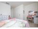 Bright bedroom featuring a vanity with lighted mirror, white dresser, and neutral carpet at 13452 Sagestone Dr, Winter Garden, FL 34787