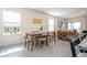 Bright dining space with a wooden table, comfortable seating, and a view of the outdoor area at 13452 Sagestone Dr, Winter Garden, FL 34787