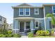 Charming two-story townhome with covered porch and well-maintained landscaping, providing excellent curb appeal at 13452 Sagestone Dr, Winter Garden, FL 34787