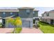 View of exterior with well manicured lawn, neutral paint, a two-car garage, and a brick paver driveway at 13452 Sagestone Dr, Winter Garden, FL 34787