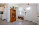 Inviting foyer with tile flooring, a wooden cabinet, shoe bench and a window providing lots of natural light at 13452 Sagestone Dr, Winter Garden, FL 34787