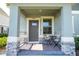 Charming front porch with stone accents and a cozy seating area at 13452 Sagestone Dr, Winter Garden, FL 34787