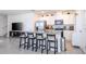 Open-concept kitchen with stainless steel appliances, granite counters, white cabinets, and a breakfast bar with seating at 13452 Sagestone Dr, Winter Garden, FL 34787