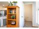 Living room view through doorway of built-in shelving, stainless appliances and half bath at 13452 Sagestone Dr, Winter Garden, FL 34787