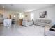 Spacious living room with neutral decor, tile floors, and ample natural light from large windows at 13452 Sagestone Dr, Winter Garden, FL 34787