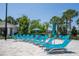 Poolside area with rows of blue lounge chairs, perfect for relaxing by the pool at 13452 Sagestone Dr, Winter Garden, FL 34787