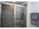 Shower stall with gray tiling, a glass door, and a shower head at 13452 Sagestone Dr, Winter Garden, FL 34787
