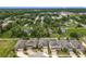 An aerial view shows well-maintained homes, lush trees, and a scenic neighborhood at 13842 Pickett Reserve Ct, Orlando, FL 32826