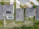 Overhead view of several homes in a neighborhood with a swimming pool and fenced backyards at 13842 Pickett Reserve Ct, Orlando, FL 32826