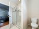 Bathroom with glass shower enclosure, tiled floor, and white toilet at 13842 Pickett Reserve Ct, Orlando, FL 32826