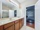 Bright bathroom features double sinks, granite countertop, and a glass-enclosed shower at 13842 Pickett Reserve Ct, Orlando, FL 32826