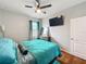 Comfortable bedroom featuring a ceiling fan, gray walls, and modern decor at 13842 Pickett Reserve Ct, Orlando, FL 32826
