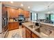 Modern kitchen features stainless steel appliances, granite countertops, and wooden cabinetry at 13842 Pickett Reserve Ct, Orlando, FL 32826
