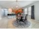 An open-concept living area featuring a kitchen with bar seating and a dining table at 13842 Pickett Reserve Ct, Orlando, FL 32826