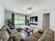 Comfortable living room with a large sectional sofa, modern lighting, and access to the outdoor patio at 13842 Pickett Reserve Ct, Orlando, FL 32826