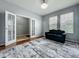 Cozy living room with french doors, neutral paint, hardwood floor, and black sofa at 13842 Pickett Reserve Ct, Orlando, FL 32826
