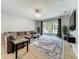 Spacious living room with tile floors, a large sectional sofa, and sliding glass doors to the patio at 13842 Pickett Reserve Ct, Orlando, FL 32826