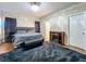 Cozy main bedroom with dark wood floors, a stylish bed, and a decorative fireplace at 13842 Pickett Reserve Ct, Orlando, FL 32826