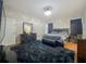 Well-lit main bedroom with hard wood floors, a modern bed, and contemporary furnishings at 13842 Pickett Reserve Ct, Orlando, FL 32826