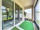 Screened patio featuring artificial grass, large sliding glass doors, and room for seating at 13842 Pickett Reserve Ct, Orlando, FL 32826