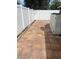 Charming backyard featuring a paved patio, white vinyl fence and convenient storage unit at 1422 Spalding Rd, Winter Springs, FL 32708