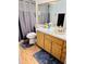 Bathroom features a wood vanity, sink and a large mirror at 1422 Spalding Rd, Winter Springs, FL 32708