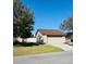 Exterior showing the side of the home with a driveway, lawn and tree at 1422 Spalding Rd, Winter Springs, FL 32708