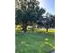 Landscaped front yard featuring lush lawn and mature trees providing ample shade at 1422 Spalding Rd, Winter Springs, FL 32708
