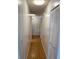 Well-lit hallway features tile flooring and white walls, complemented by a closet at 1422 Spalding Rd, Winter Springs, FL 32708