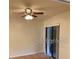 Bedroom features a ceiling fan, window and sliding door access to an outside area at 1422 Spalding Rd, Winter Springs, FL 32708