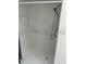 Stand-up shower with white walls and a mounted shower head at 1422 Spalding Rd, Winter Springs, FL 32708