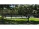 Community tennis court nestled among mature trees at 1422 Spalding Rd, Winter Springs, FL 32708