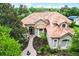 Beautiful single Gathering home with a red-tiled roof surrounded by lush greenery and mature trees at 1453 Langham Ter, Lake Mary, FL 32746
