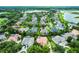Aerial view of a neighborhood featuring homes with pools and landscaping near a large lake at 1453 Langham Ter, Lake Mary, FL 32746