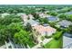 Aerial view showcasing a home with lush landscaping, palm trees, and a terracotta roof in a residential area at 1453 Langham Ter, Lake Mary, FL 32746
