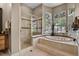 Elegant bathroom featuring a soaking tub and glass enclosed shower at 1453 Langham Ter, Lake Mary, FL 32746