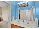Bright blue bathroom with double sinks and view into bedroom at 1453 Langham Ter, Lake Mary, FL 32746