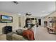 Expansive bonus room including a sitting area, desk, shelving, and TV at 1453 Langham Ter, Lake Mary, FL 32746