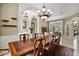 Charming dining area features a long wooden table and views into the formal living room at 1453 Langham Ter, Lake Mary, FL 32746