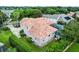 Aerial view displaying a home with a terracotta roof, a screened-in pool, and well-maintained landscaping at 1453 Langham Ter, Lake Mary, FL 32746