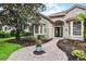 Charming stone and stucco home with a brick pathway and meticulously landscaped front yard at 1453 Langham Ter, Lake Mary, FL 32746