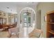 Elegant foyer with high ceilings, decorative columns, and a view into the dining area at 1453 Langham Ter, Lake Mary, FL 32746