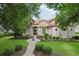 Charming home featuring a brick walkway, stone accents, well-maintained lawn, and mature landscaping at 1453 Langham Ter, Lake Mary, FL 32746