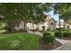Well-maintained home boasting a brick walkway, manicured lawn, stone accents, and lush, mature trees at 1453 Langham Ter, Lake Mary, FL 32746
