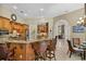 Bright kitchen with stone countertops, stainless steel appliances, and a large breakfast bar at 1453 Langham Ter, Lake Mary, FL 32746