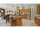Kitchen with wood cabinets, granite counters, stainless steel appliances and center island at 1453 Langham Ter, Lake Mary, FL 32746