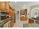 Gourmet kitchen with granite countertops, wooden cabinetry and stainless steel appliances at 1453 Langham Ter, Lake Mary, FL 32746