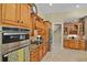 Gourmet kitchen with granite countertops, wooden cabinetry and stainless steel appliances at 1453 Langham Ter, Lake Mary, FL 32746