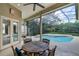 Screened lanai with a dining table overlooking the pool and lush backyard at 1453 Langham Ter, Lake Mary, FL 32746