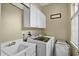 Well-lit laundry room featuring a utility sink, washer, and dryer at 1453 Langham Ter, Lake Mary, FL 32746